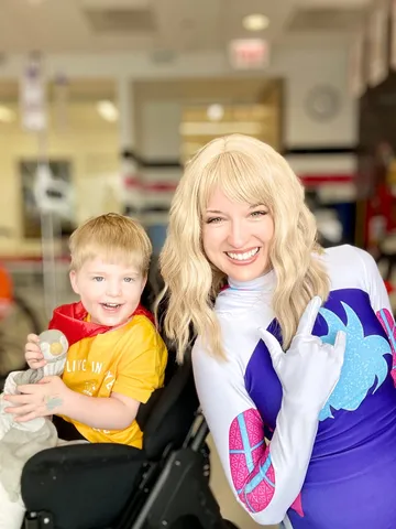 Ghost Spider posing with a young boy at a children's hospital visit
