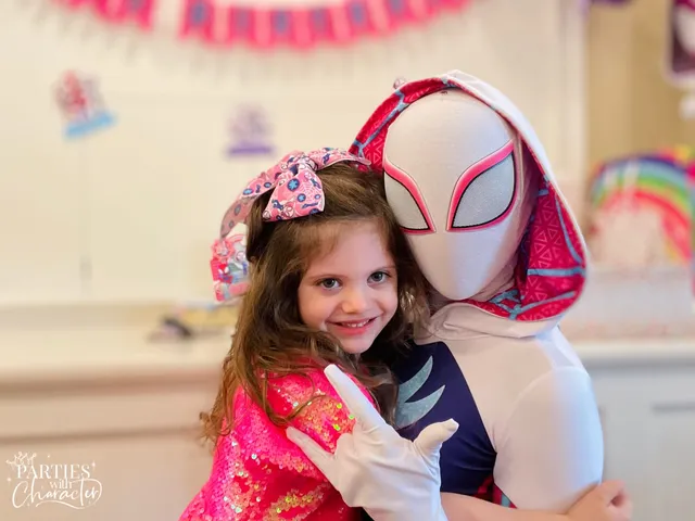 Ghost Spider giving a thumbs up with a young girl in pink