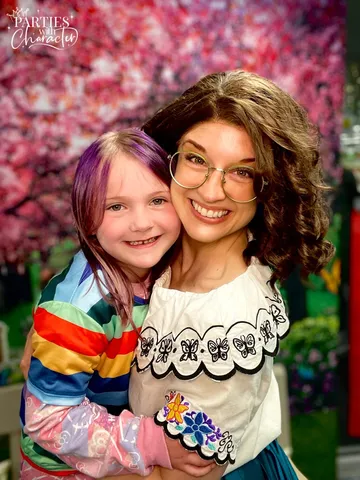 Mirabel with a girl wearing a colorful rainbow-sleeved outfit