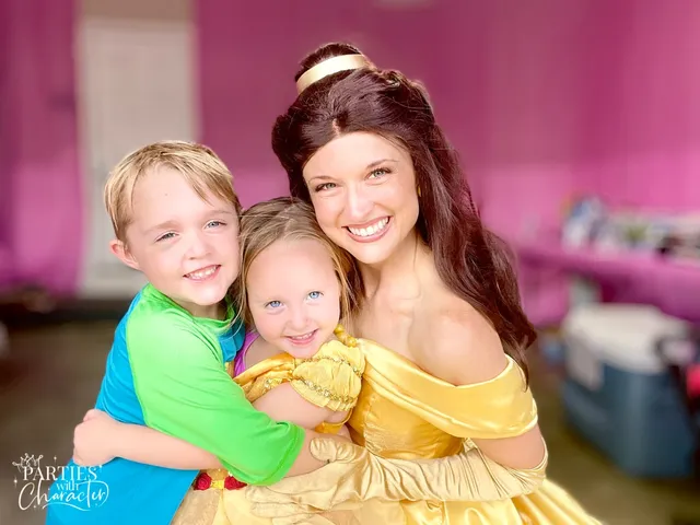 Belle with two young siblings at a tea room birthday party
