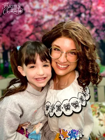 Mirabel smiling closely with a young girl with bangs
