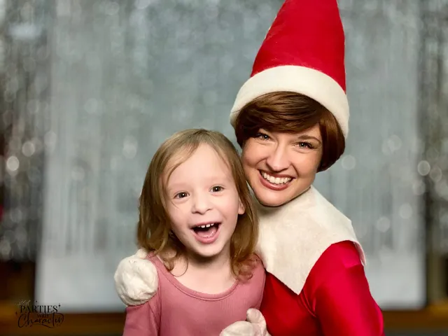 Elf on the Shelf making a young girl laugh in a library photo booth