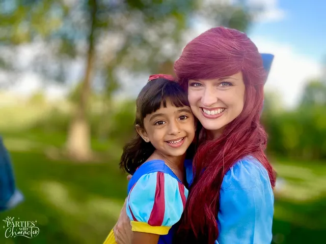Ariel posing outdoors with a girl dressed as Snow White