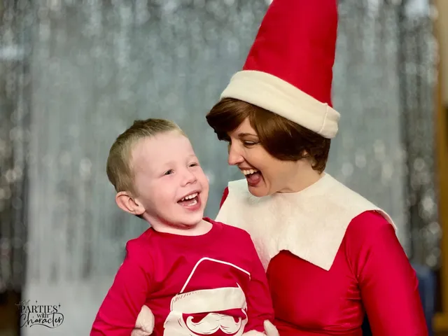 Elf on the Shelf holding a young boy clutching a wrapped gift at the library