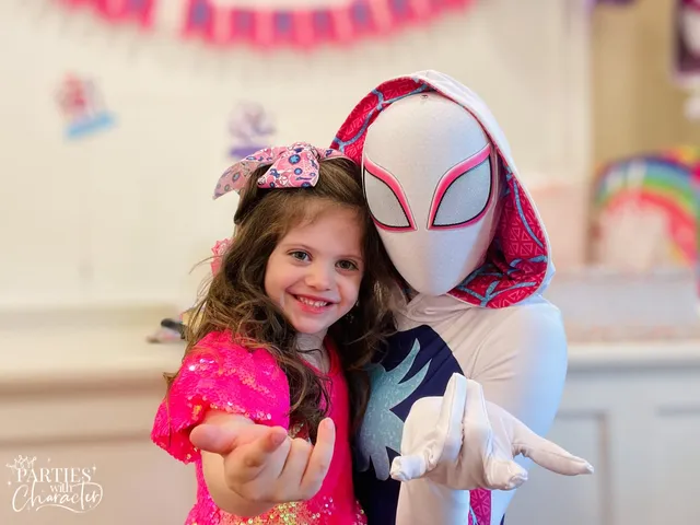 Ghost Spider reacting with a delighted young girl reaching out her hand