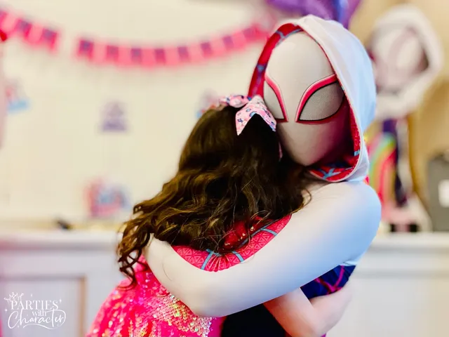 Ghost Spider in her mask and hood hugging a girl in a pink sequin dress at an indoor party