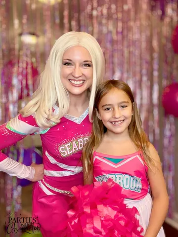 Addison in her Seabrook cheer uniform beside a girl in a matching cheer outfit