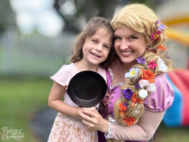Rapunzel and a smiling girl holding up a frying pan outdoors
