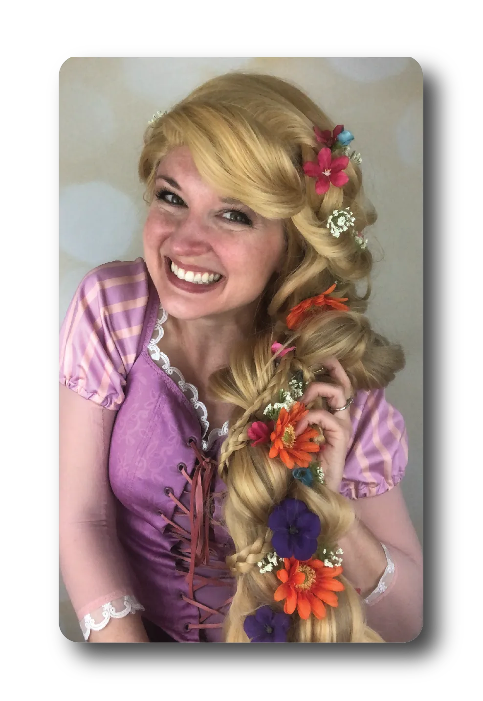 Rapunzel from Tangled with long golden hair in purple gown